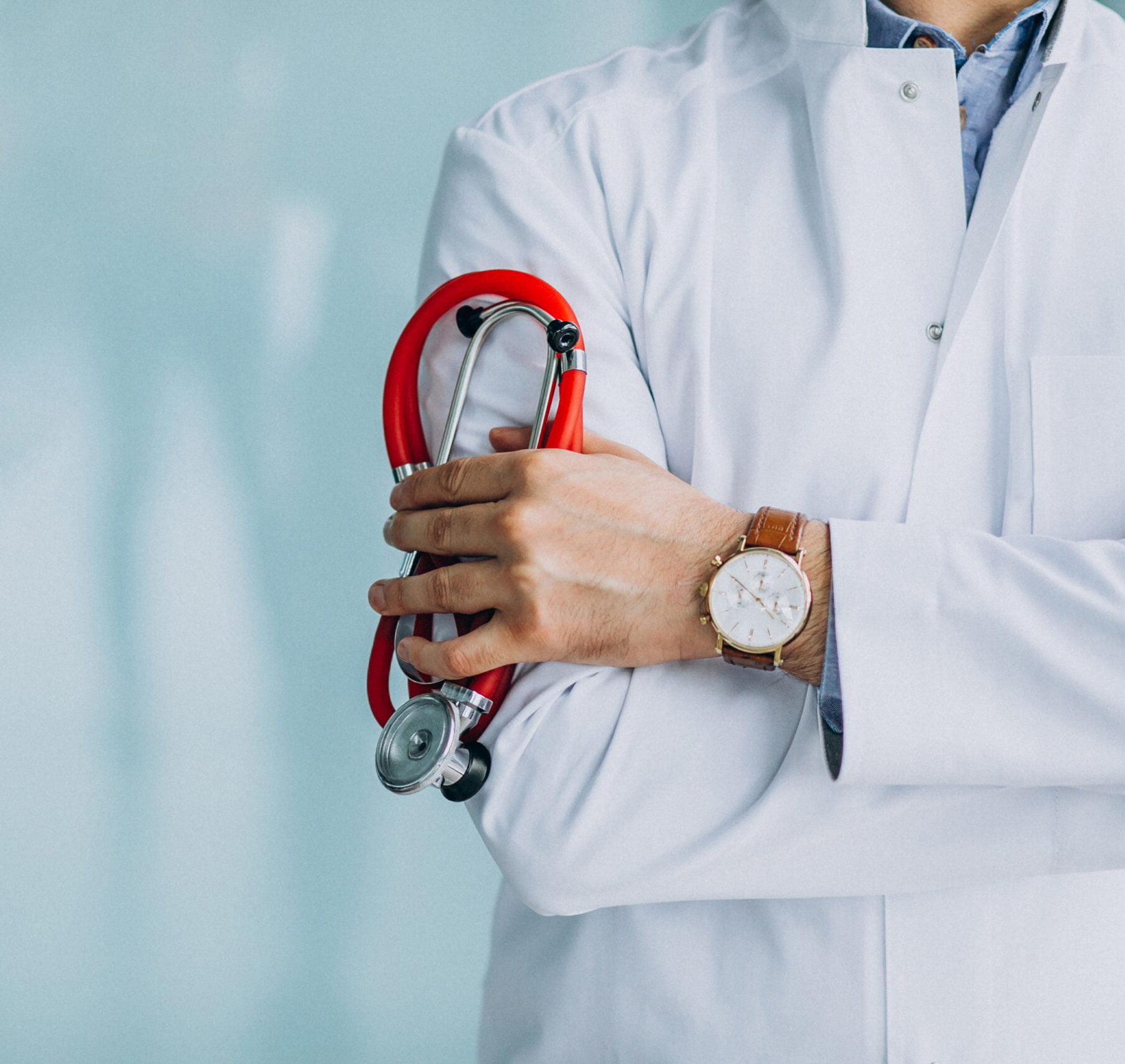 Young handsome physician in a medical robe with stethoscope Young handsome physician in a medical robe with stethoscope
